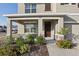 Inviting front porch with stone accents, lush landscaping, and a stylish entrance at 2604 Knight Island Dr, Brandon, FL 33511