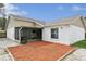 Exterior shot of home's backyard featuring a screened-in porch and gravel at 2799 Wesleyan Dr, Palm Harbor, FL 34684