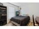 Simple bedroom featuring dark wood floors, window, and built-in storage at 2799 Wesleyan Dr, Palm Harbor, FL 34684