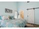 Well-lit main bedroom showcases a sliding barn door leading to the bathroom at 2799 Wesleyan Dr, Palm Harbor, FL 34684