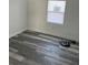 This bedroom features grey wood-look floors, a window, and neutral paint at 3110 N Massachusetts Ave, Tampa, FL 33603