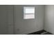 A bright bedroom with wood floors, a window with blinds, and a closet for storage at 3110 N Massachusetts Ave, Tampa, FL 33603