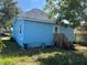 Back exterior of the light blue home featuring a private yard at 3110 N Massachusetts Ave, Tampa, FL 33603