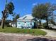 Charming light blue bungalow with a metal roof and a quaint front porch at 3110 N Massachusetts Ave, Tampa, FL 33603