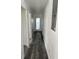 Hallway with wood floors leads to a glass door and has freshly painted white walls at 3110 N Massachusetts Ave, Tampa, FL 33603