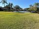 Well-maintained backyard with a grassy area and view of the lake at 3150 Mission Grove Dr # 3150, Palm Harbor, FL 34684