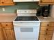 White electric stove with wooden cabinets and countertops in the kitchen at 3150 Mission Grove Dr # 3150, Palm Harbor, FL 34684