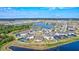 Aerial view of a community featuring houses surrounding ponds and cul-de-sacs at 3192 King Fern Dr, Wimauma, FL 33598