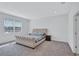 Serene main bedroom with a tufted headboard bed, soft carpeting, and natural light from the window at 3192 King Fern Dr, Wimauma, FL 33598