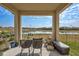 View of the water from the covered lanai seating area with woven chairs and storage box at 3192 King Fern Dr, Wimauma, FL 33598