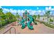 Community playground with multiple slides, climbing structure, and surrounding benches at 3192 King Fern Dr, Wimauma, FL 33598