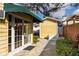 A Generac generator sits outside the back entrance with french doors covered by a green awning at 3203 W San Carlos St, Tampa, FL 33629