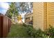 A lush green lawn and wood fence surround a wooden playground in this well-maintained backyard at 3203 W San Carlos St, Tampa, FL 33629