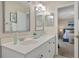 Bright bathroom featuring double sinks, mirrors and vanity, with the primary bedroom visible at 3203 W San Carlos St, Tampa, FL 33629