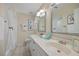 Well-lit bathroom with double sinks, vanity with storage, and large mirrors at 3203 W San Carlos St, Tampa, FL 33629