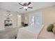 Primary bedroom featuring neutral walls, ceiling fan, and an ensuite bathroom at 3203 W San Carlos St, Tampa, FL 33629