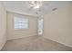 Bedroom featuring neutral carpet, a ceiling fan, and an ensuite bathroom visible through the doorway at 3203 W San Carlos St, Tampa, FL 33629