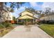 Charming yellow two-story home with a front porch, basketball hoop, and mature landscaping at 3203 W San Carlos St, Tampa, FL 33629