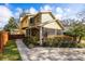 Charming yellow two-story home with a screened in porch and lovely landscaping at 3203 W San Carlos St, Tampa, FL 33629