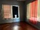 Shows a bedroom with wood floors, dark walls, and two windows at 3208 N 15Th St, Tampa, FL 33605