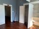 Shows a bedroom with wood floors, blue walls, and closet space at 3208 N 15Th St, Tampa, FL 33605