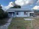 Street-level view of home with mature tree, chain link fence, and overcast sky at 3208 N 15Th St, Tampa, FL 33605