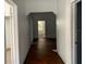 View down hardwood hallway with several doorways and natural light at the end at 3208 N 15Th St, Tampa, FL 33605