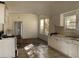 Shows a kitchen with tile flooring, range, sink, window, and white cabinets at 3208 N 15Th St, Tampa, FL 33605