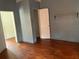 Shows a living room with wood floors, dark walls, and doorways at 3208 N 15Th St, Tampa, FL 33605