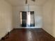 View of the living room with hardwood floors, ceiling fan, and natural light at 3208 N 15Th St, Tampa, FL 33605