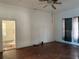 View of the living room with hardwood floors, ceiling fan, and natural light at 3208 N 15Th St, Tampa, FL 33605