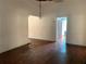 View of the living room with hardwood floors, interior entry door, and plaster walls at 3208 N 15Th St, Tampa, FL 33605