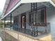 Close-up shot of porch with decorative ironwork railing, columns, and trim at 3208 N 15Th St, Tampa, FL 33605