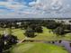 Expansive golf course with lush greenery, mature trees, a water feature and community in view at 37027 Lakota Ct, Zephyrhills, FL 33542