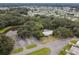 Aerial view of community buildings next to a pond and lush landscaping at 37027 Lakota Ct, Zephyrhills, FL 33542