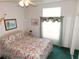 Inviting bedroom with floral bedding, a window with valance, and a ceiling fan at 37027 Lakota Ct, Zephyrhills, FL 33542