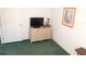 Bedroom features a traditional dresser and television, complemented by an adjacent door at 37027 Lakota Ct, Zephyrhills, FL 33542