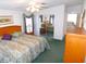 Bright bedroom featuring a mirrored closet, ceiling fan, and soft, floral bedding at 37027 Lakota Ct, Zephyrhills, FL 33542