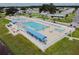 An aerial view of the community pool with ample seating and a well-maintained pool deck at 37027 Lakota Ct, Zephyrhills, FL 33542