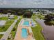 A beautiful aerial view of the community pool, deck, and luxurious seating area at 37027 Lakota Ct, Zephyrhills, FL 33542