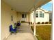 Relaxing covered porch featuring comfortable seating and a welcoming entrance at 37027 Lakota Ct, Zephyrhills, FL 33542