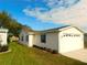 Exterior view of a well-maintained home featuring a garage and manicured landscaping at 37027 Lakota Ct, Zephyrhills, FL 33542