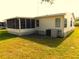 View of the exterior featuring a screened-in porch and central AC unit at 37027 Lakota Ct, Zephyrhills, FL 33542