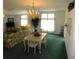 Spacious living and dining area featuring classic decor and large windows at 37027 Lakota Ct, Zephyrhills, FL 33542