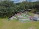 Aerial view of a fun mini golf course with lush landscaping and mature trees at 37027 Lakota Ct, Zephyrhills, FL 33542