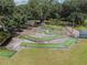 Aerial view of a fun mini golf course with lush landscaping and mature trees at 37027 Lakota Ct, Zephyrhills, FL 33542