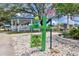 Betmar Miniature Golf Course sign with green statue of a golfer, white rock and shaded gazebo at 37027 Lakota Ct, Zephyrhills, FL 33542