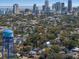 Aerial view of home nestled among trees with water tower, with downtown skyline in distance at 468 11Th N Ave, St Petersburg, FL 33701