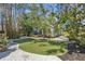 Manicured backyard with artificial turf, a gravel walkway, and privacy landscaping at 468 11Th N Ave, St Petersburg, FL 33701