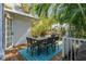 Outdoor dining area with a table and seating, shaded by mature palm trees at 468 11Th N Ave, St Petersburg, FL 33701